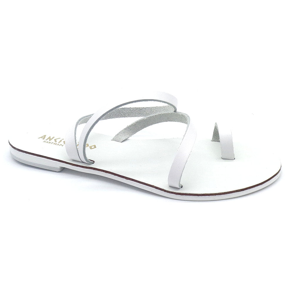 White sandal with thin straps on a white background