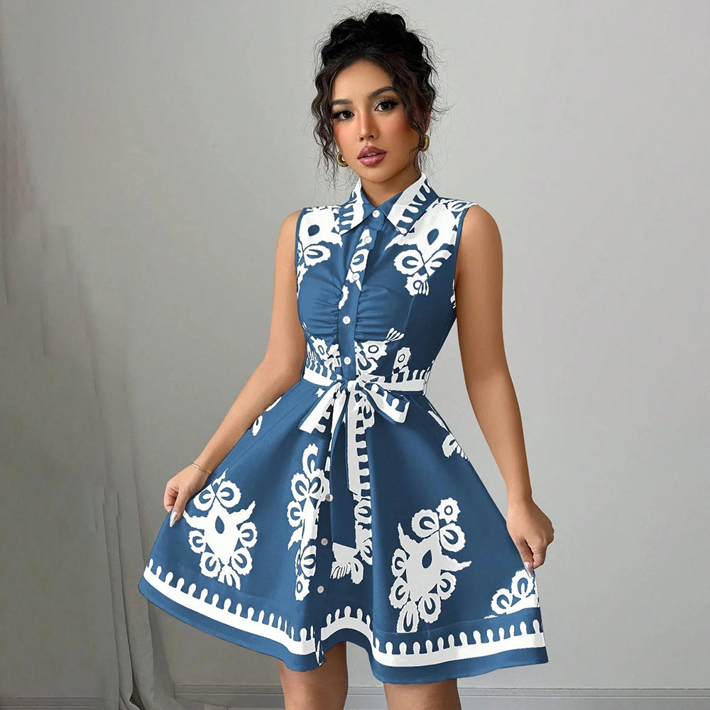 Woman wearing a blue dress with white patterns against a gray background