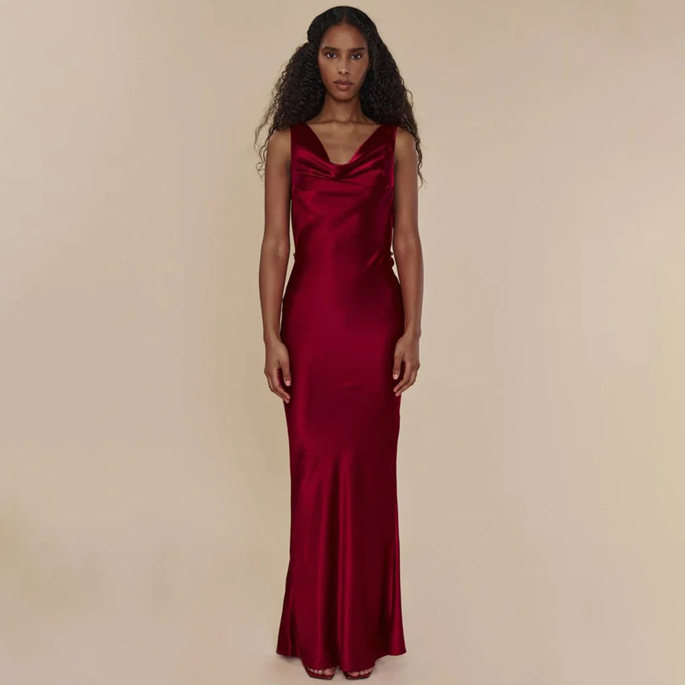 Woman wearing a red evening gown against a beige background
