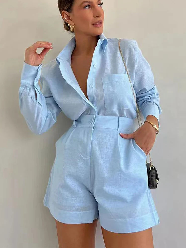 Woman wearing a light blue outfit with a plain background