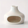 White ceramic pet bed with a circular cutout on a light gray background