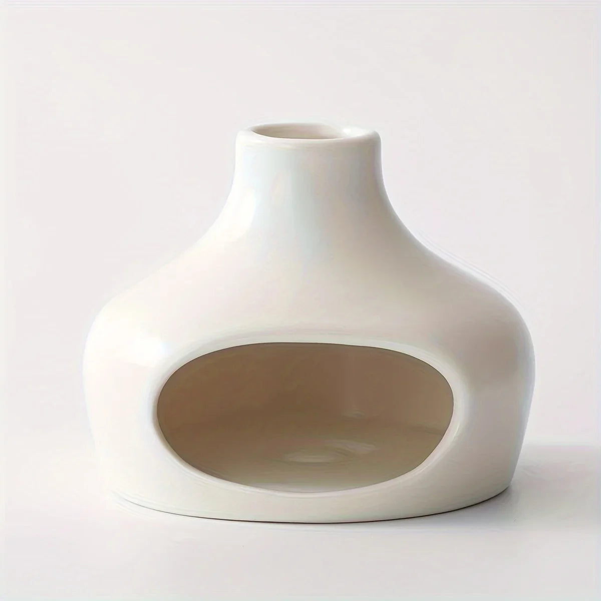 White ceramic pet bed with a circular cutout on a light gray background