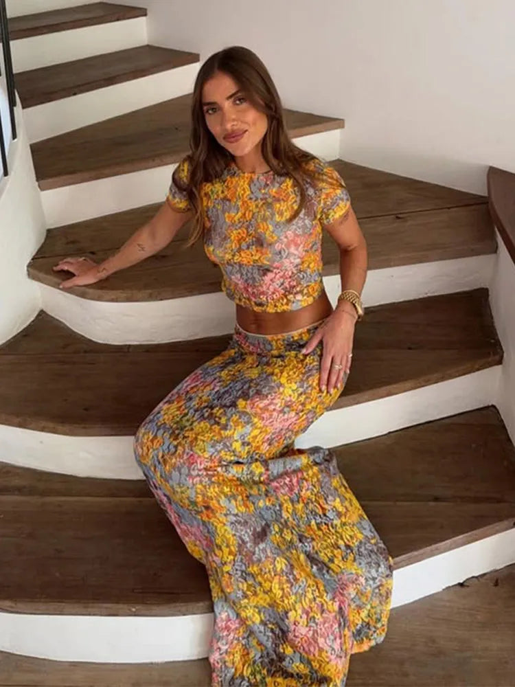 Woman in a floral outfit sitting on a staircase
