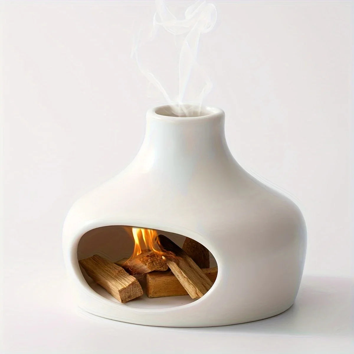 White ceramic fireplace with wood inside on a white background