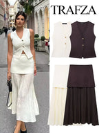 Woman wearing a white top and black skirt with 'Trafza' branding.