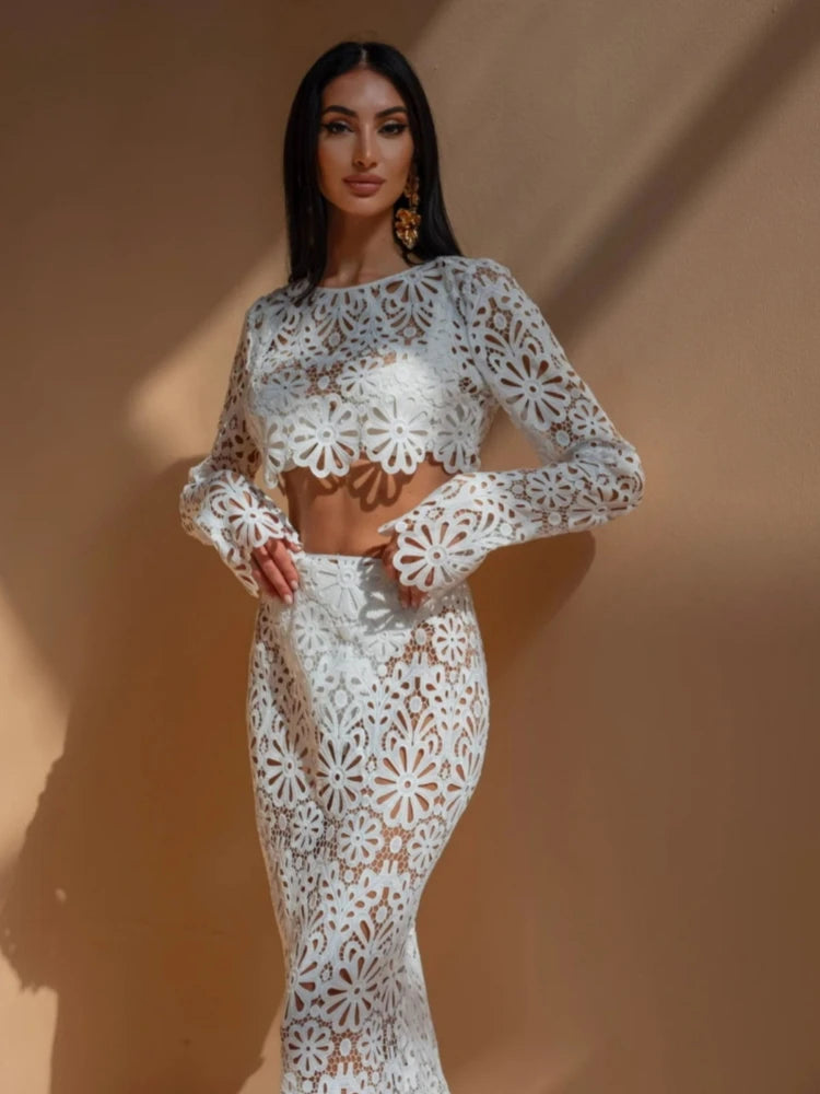 Woman wearing a white lace outfit against a beige background