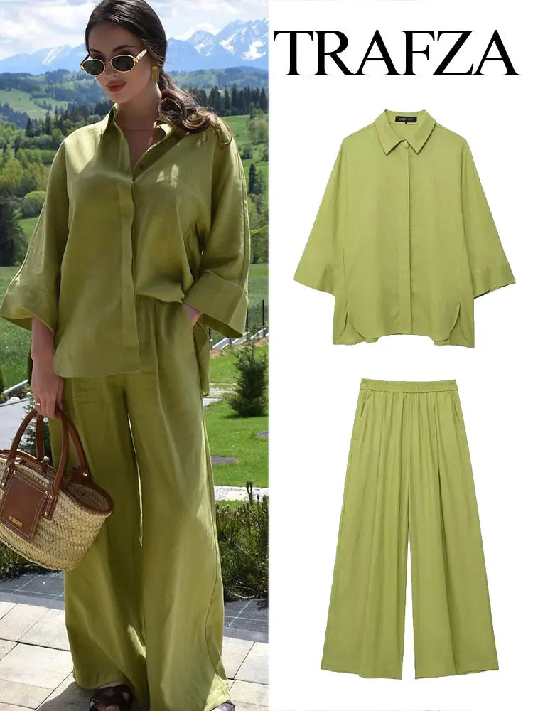 Woman wearing a green outfit with a scenic background, featuring Trafza branding.
