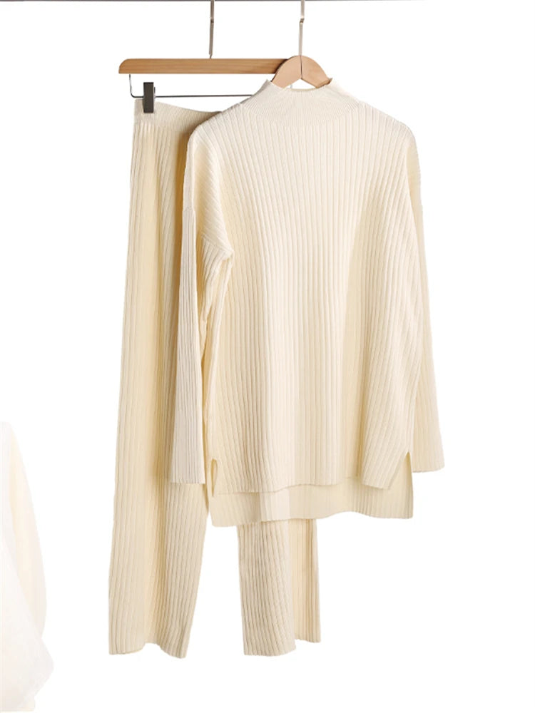 Beige knit outfit on a hanger against a white background