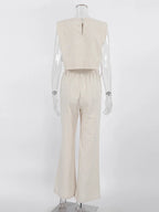 Mannequin wearing a beige sleeveless top and pants on a white background
