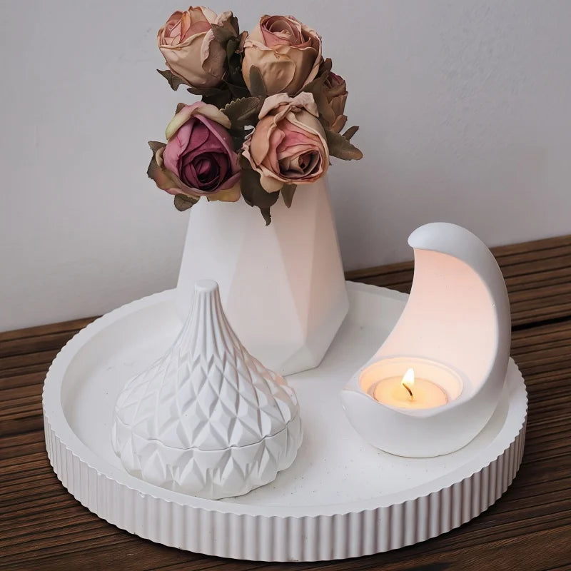 Decorative white swan with a candle and vase of flowers on a wooden surface