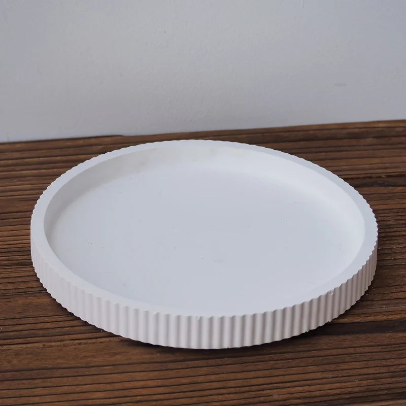 White ceramic plate with ribbed texture on a wooden surface