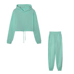 Mint green hoodie and pants set on a white background