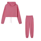 Pink hoodie and pants set on a white background
