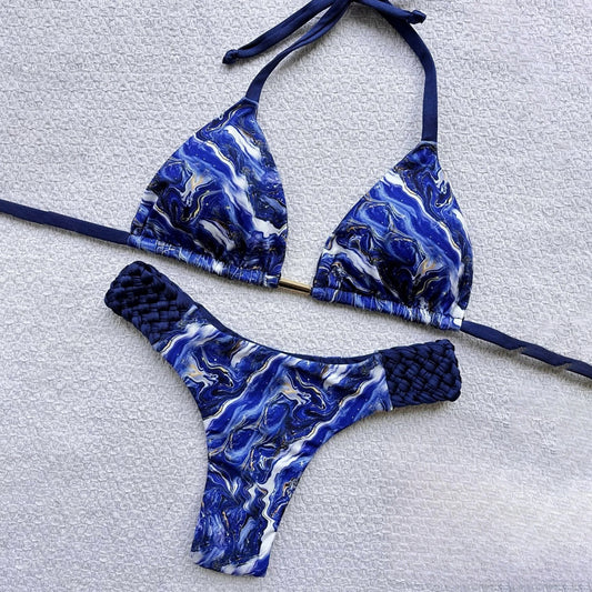 Blue and white marbled bikini set on a light gray background